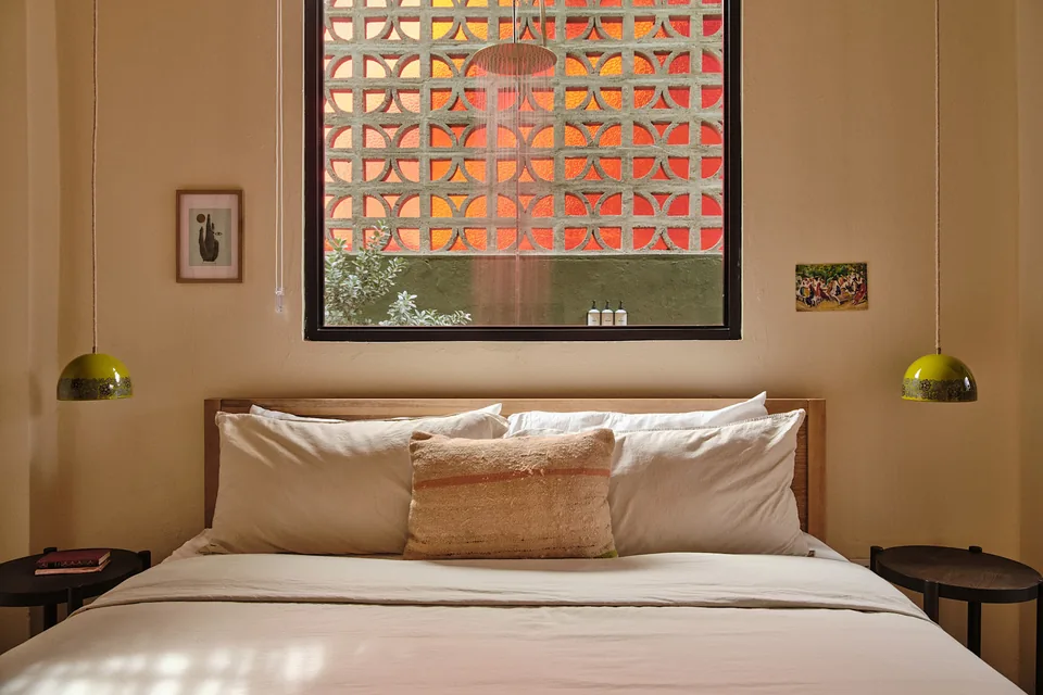 King bed with original tiles and patterned breeze blocks in Verde 2