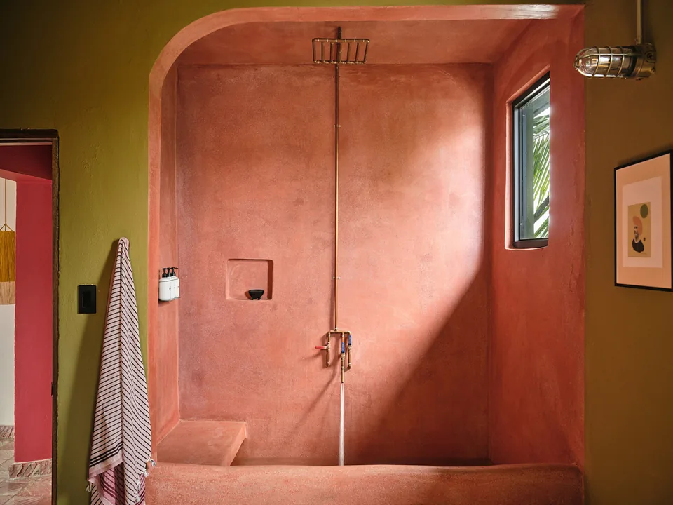 Indoor soaking tub and rain shower in red polished concrete in Verde 4